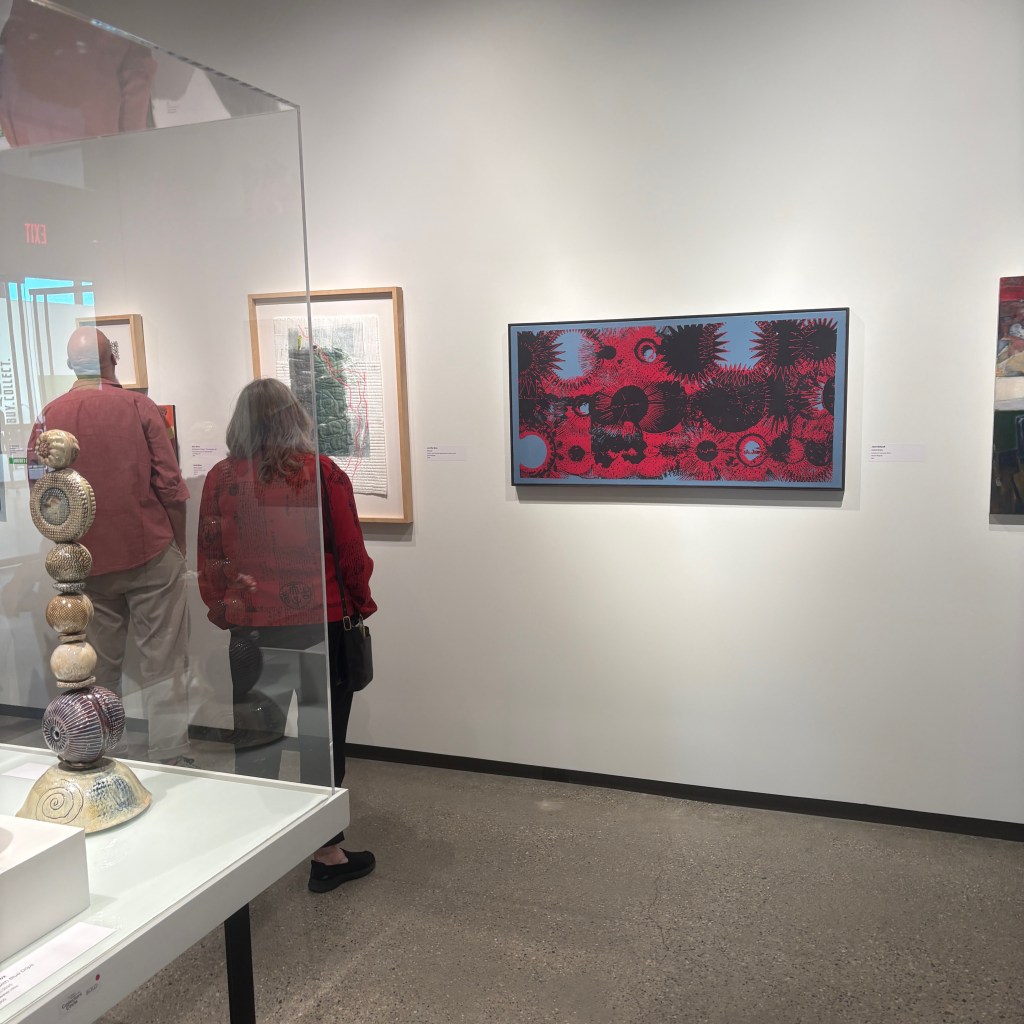 A painting by Jack Bidwell hanging on a gallery wall during an exhibition